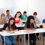 college-students-writing-at-desk-photo