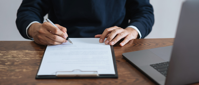person-signing-document700-3001